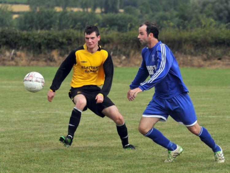 William Flood (Thomastown United A) and Seamus McGrath (Fort Rangers) race for possession. Photo: Michael Brophy