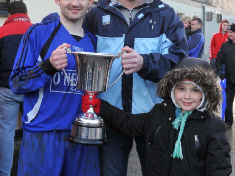 Davy Byrne and Emiilie Doyle, brother and niece of the late Ken and Michael Byrne, present the Division Two Byrne Memorial Cup to Freebooters B captain Shane Kelly. Photo: Michael Brophy
