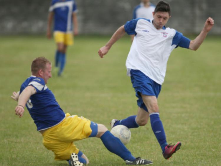 Aaron Molloy (Freebooters) is challenged by Jonathan Kennedy (Cashel Town) during the Moc Lawlor Memorial Tournament match on the Fair Green. (Photo: Eoin Hennessy)