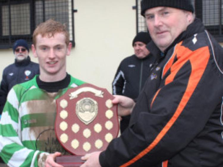 John Corrigan, chairman of the Kilkenny & District League, presents Evergreen's four-goal hero Cian Morton with the Henderson Youths' Shield. Photo: Eoin Hennessy