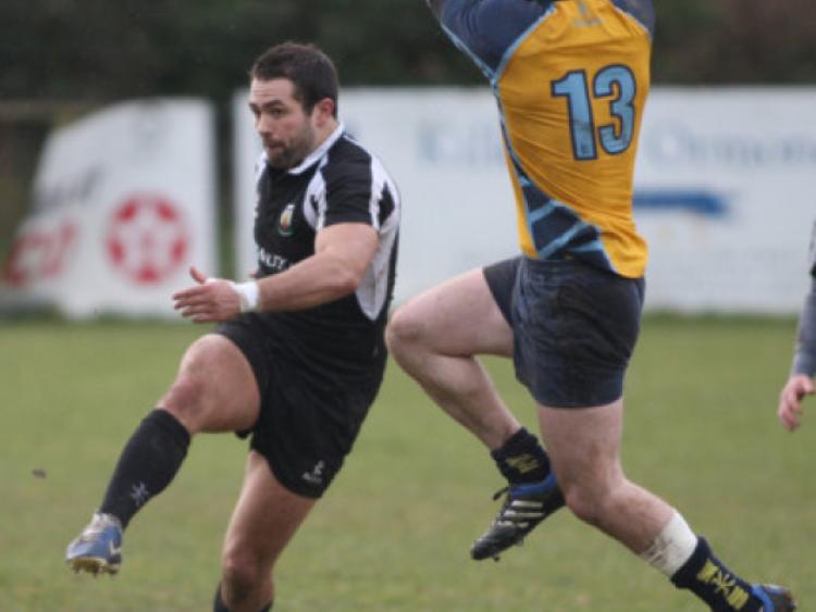 Joe Manuel (Kilkenny) kicks the ball down the line as Alan Dixon (Clondalkin) closes in during the Towns Cup second round match in Foulkstown.  (Photo: Eoin Hennessy)