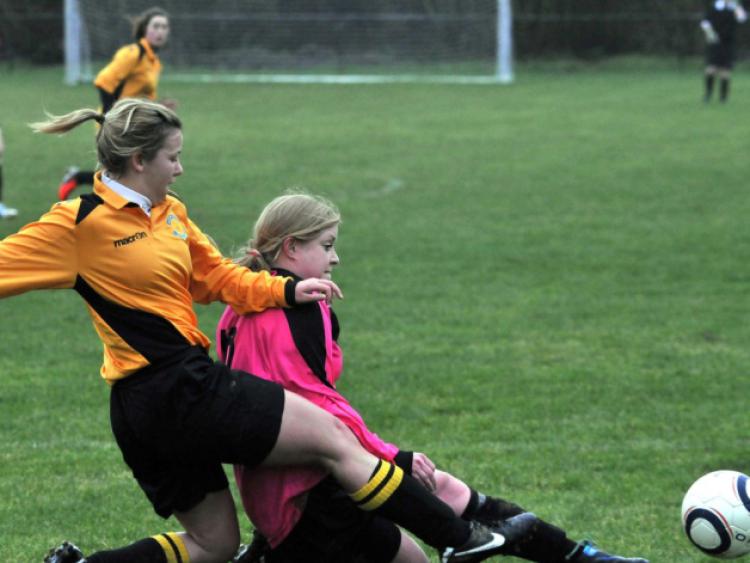 Laura Dooley (Kilkenny & District League) in a crunching challenge with Ali Lenehan (Combined Counties). Photo: Michael Brophy