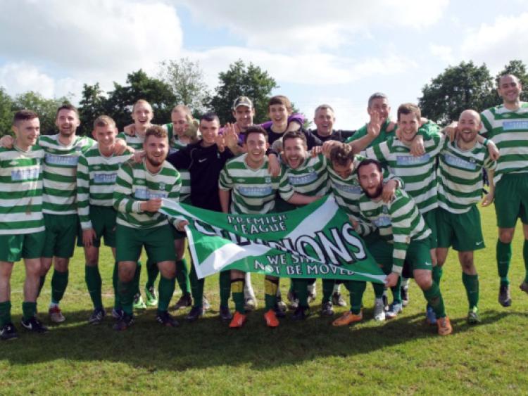 Fab five! The Evergreen A players, together with manager Eddie McEvoy and assistant John Treacy, celebrate winning their fifth Premier Division title in a row. Photo: Michael Brophy
