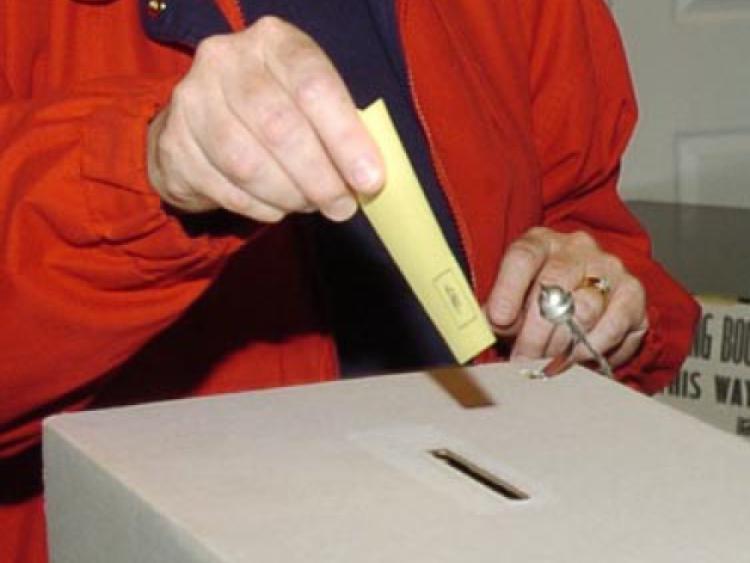 Saskatoon, SK - 061505 - Deputy Returning Officer Della Huckabay,right, watches as voter Kathy Genereux casts her ballot wednesday at South Corman Park school in elections following a restructuring of school divisions.      Greg Pender/Saskatoon StarPhoenix