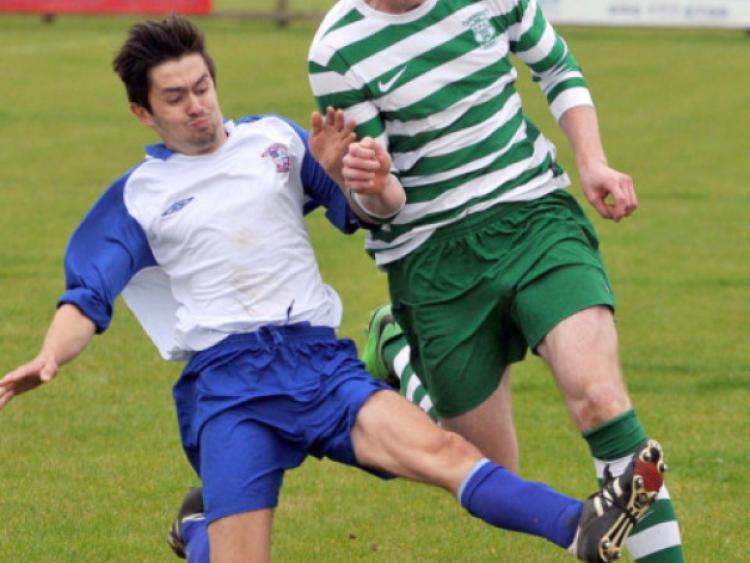 Jack Poyntz (Freebooters A) slides in to challenge Sean Barcoe (Evergreen A) during their Premier Division clash on the Kells Road. Photo: Michael Brophy