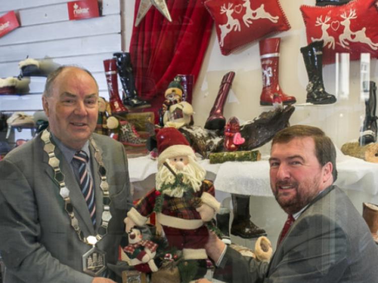 Business Community Get Behind A Very Kilkenny ChristmasThe local business community is getting behind Kilkennys inaugural Christmas festival  A Very Kilkenny Christmas  with a Winter Wonder Window competition to award the most festive window display in the run-up to Christmas. Kilkenny Chamber is sponsoring the initiative with Shop Local vouchers of �400 and �200 awarded to the respective business and stylist behind the winning window display. Pictured are Kilkenny Chamber President Donie Butler and Gary Graham, Chairman, A Very Kilkenny Christmas adding some festive d�cor to the window of Graham Shoes on Friary Street. Photo: Pat Moore.