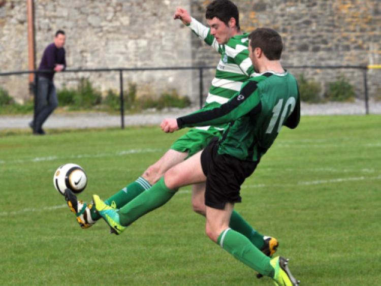 Ger Brennan (Tullaroan) and Gerry Walsh (Evergreen C) go toe-to-toe in the Division Two Ken and Michael Byrne Memorial Cup final at Derdimus on Saturday. Photo: Michael Brophy