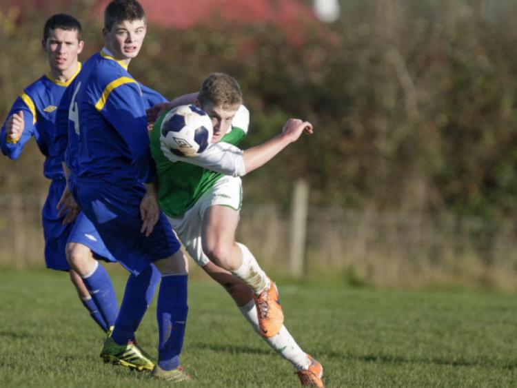 Cian Loy (Kilkenny & District League) bends his shot around the North Tipperary defence during Saturday's inter-league game in Drombane. Photo: Andy Jay