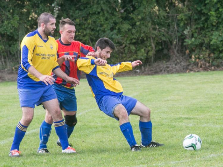Kevin Davitt (Bridge United B) is held back by Paul Deniffe (Ormonde Villa) during the Division Two game in Goresbridge on Sunday. Photo: Pat Moore