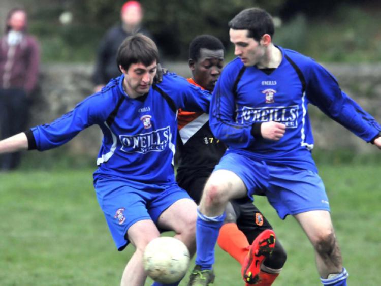 Shane Kelly and Richie Coyne (Freebooters B) team up to block out Gabriel Ajar (St Mary's). Photo: Michael Brophy