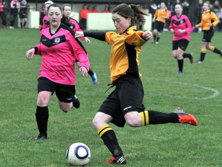 Jenny Brennan (Kilkenny & District League) takes a shot as Jackie Glennon (Combined Counties) closes in. Photo: Michael Brophy