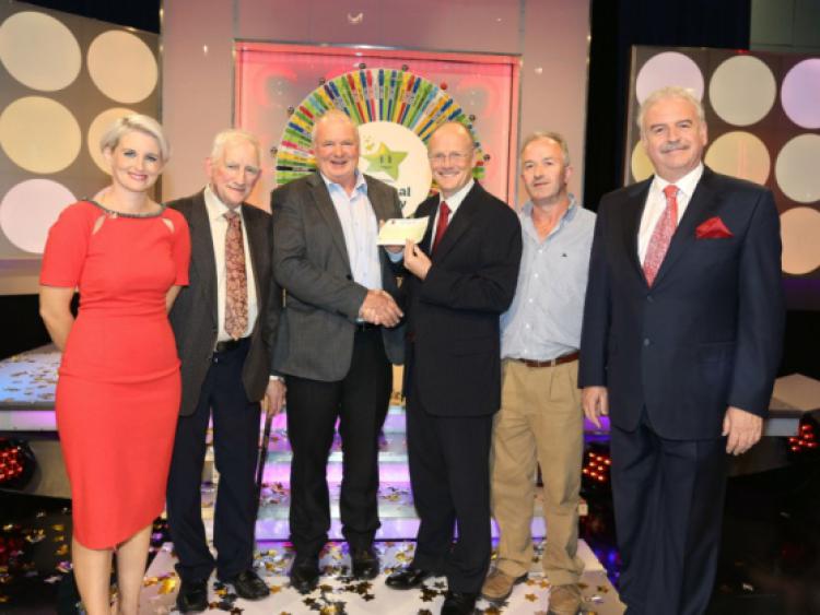 Ned Costigan from Grovine, Co. Kilkenny has won �43,400 on the National Lottery on Saturdays (14th September 2013) Winning Streak game show on RTE. Pictured at the presentation of the winning cheques were from left: Sinead Kennedy, Winning Streak game show co-host; James Delaney, National Lottery ticket selling agent, Delaneys Bar & Grocery, Patrick Street, Kilkenny; Ned Costigan, the winning player; Harry  Cooke, Head of Operations and Corporate Affairs, The National Lottery; Pat Walsh, National Lottery ticket selling, Delaneys Bar & Grocery, Patrick Street, Kilkenny and Marty Whelan, Winning Streak game show co-host. Pic: Mac Innes Photography