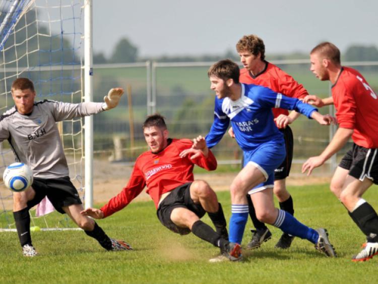 Barry Whelan (Thomastown United) finds room to shoot despite the crowded New Ross box during Sunday's Leinster Junior Cup clash in Thomastown. Photo: Michael Brophy