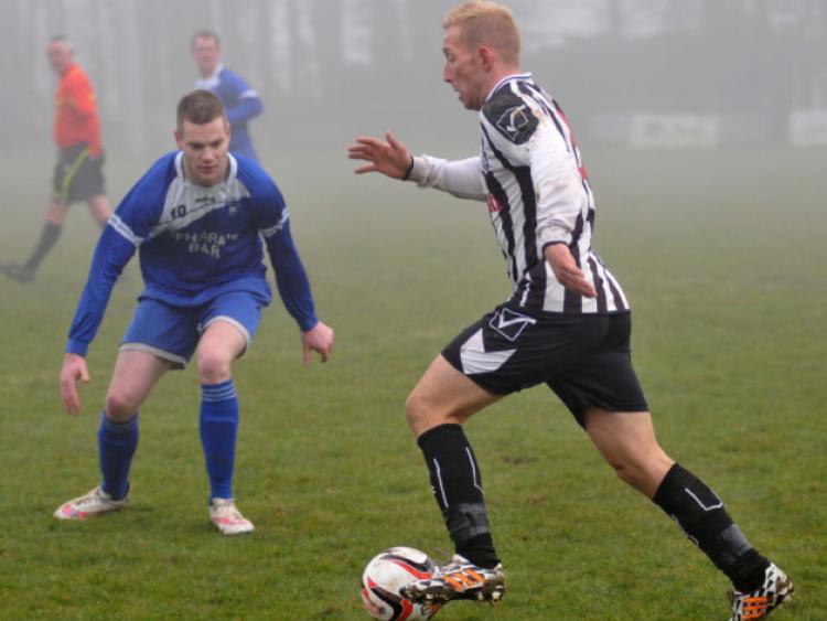 Michael Comerford (Newpark A) looks for space to get his cross in as Steven Connolly (Thomastown United A) closes him down. Photo: Michael Brophy