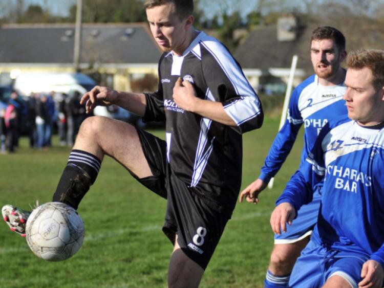 Conor Coffey (Stoneyford United) keeps control of the ball as Neil O'Mara and Andy Kavanagh (Thomastown United) look on. Photo: Michael Brophy