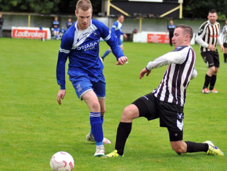 Stephen Dawson (Newpark A) slides in to try and stop Steven Connolly (Thomastown United A) during their Premier Division clash in Buckley Park on Sunday morning. Photos: Michael Brophy