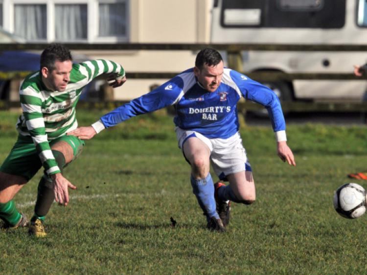 Ger Galvin (Evergreen B) and Damien Raggett (Freebooters A) keep their eyes on the ball during Sunday's Premier Division game at the Fair Green. Photo: Michael Brophy