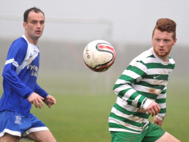 Paul Dempsey (Thomastown United A) and Conor English (Evergreen A) eye the ball. Photo: Michael Brophy
