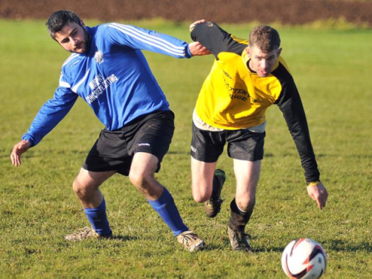 David Forristal (Fort Rangers) races to the ball ahead of James Moran (Stoneyford United). Photo: Michael Brophy