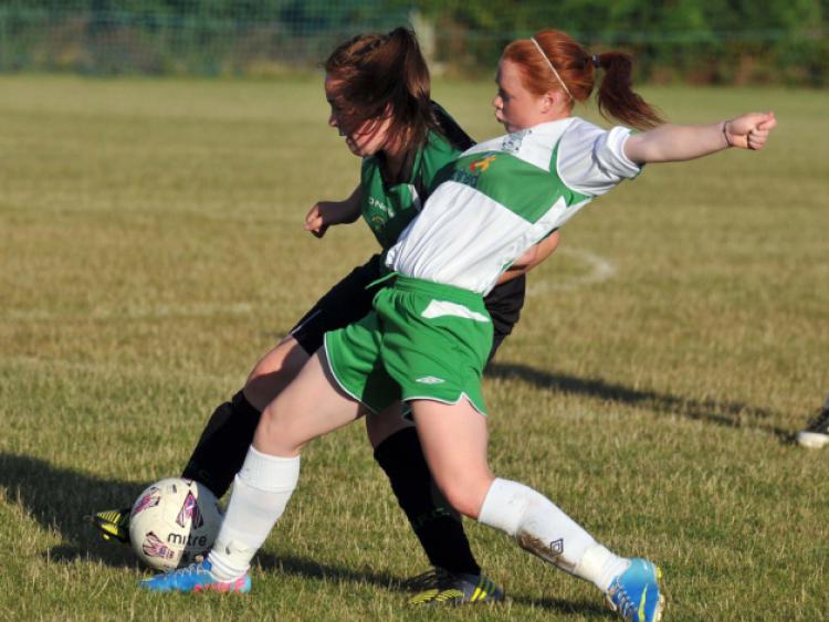 Jenny Clifford (Evergreen) reaches in to challenge Chloe Murphy (Peamount) for possession during the FAI Women's Under-16 Cup clash. Photo: Michael Brophy