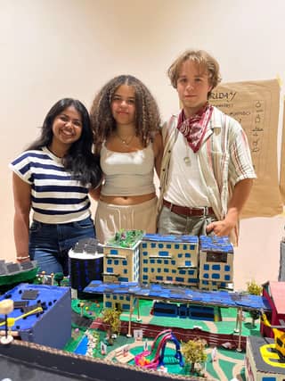 Rose, Susan and Rory at the camp in Germany with their miniature sustainable city blocks