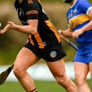 A Kilkenny player wearing a skort handpasses the sliothar. Picture: Sportsfile