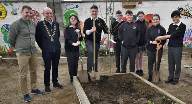 Dennis Doyle, TYCo-ordinator at Scoil Aireagail in Ballyhale, with Kilkenny Lions Club President, Gerry McGovern, and students, prepare to sow a Pear Tree in the new Organic Garden. Picture: Harry R
