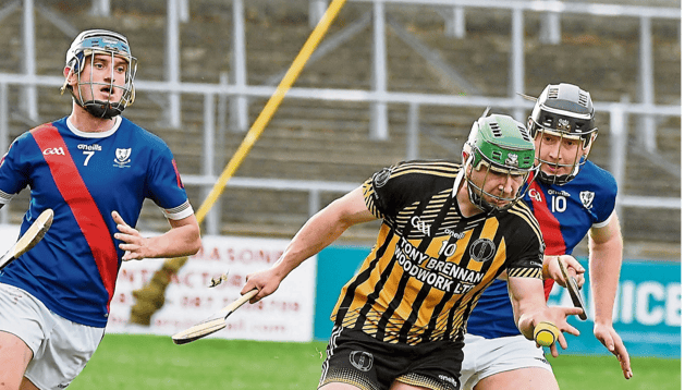 Alexander Rafter gets his handpass away from two Drumcullen players. Picture: Willie Dempsey