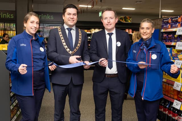 Mayor Andrew McGuinness cuts the tape on the new Tesco Kilkenny store with the help of Store Manager Colm Cleary and staff members Elma and Nadia PICTURE: David Clynch