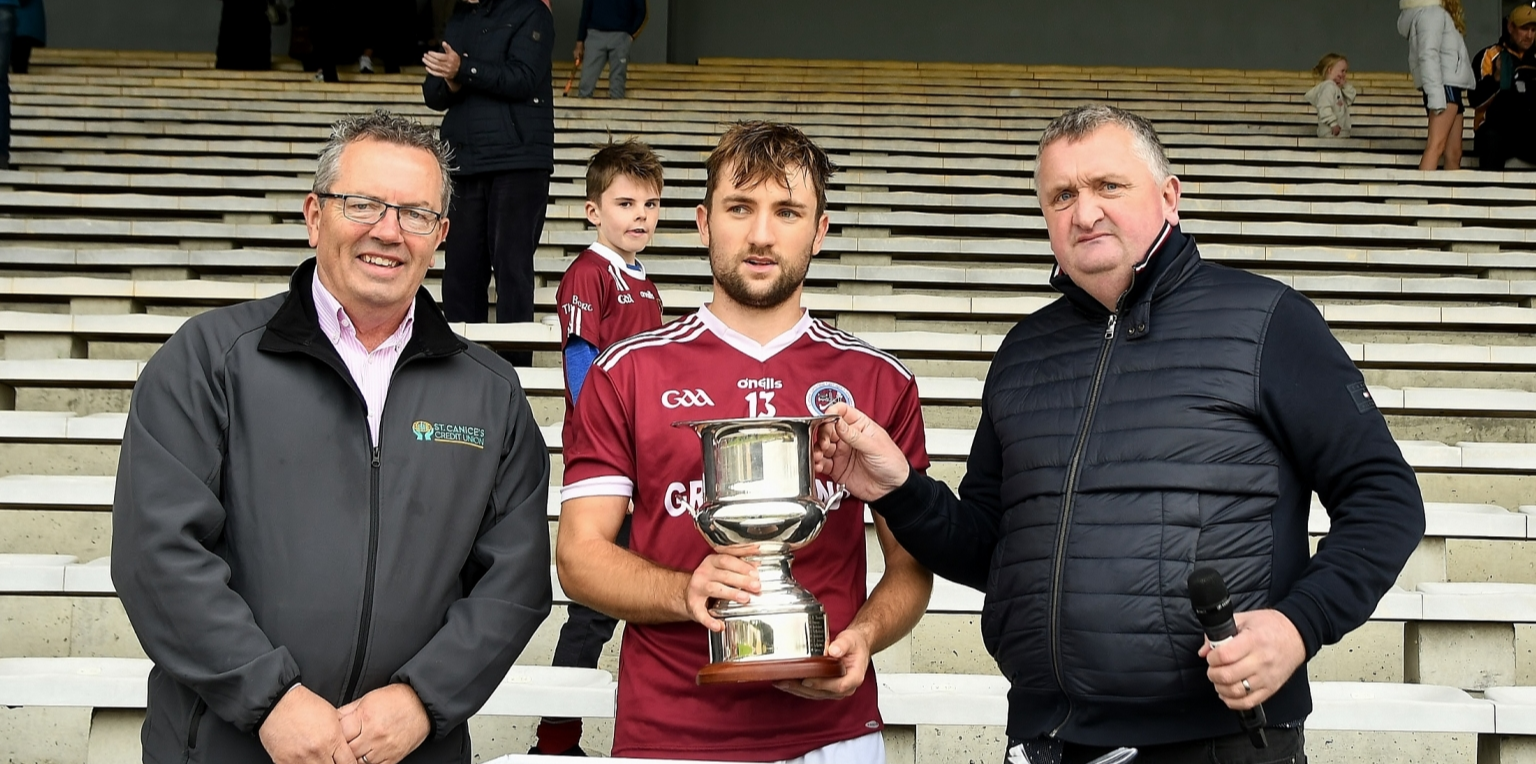 Dicksboro captain Bill Sheehan receives the league trophy from John Gavin and PJ Kenny.  Picture: Willie Dempsey