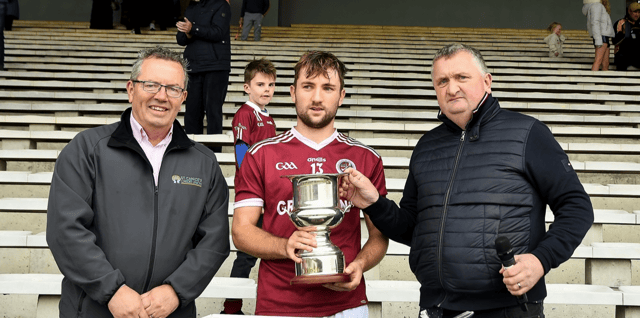 Dicksboro captain Bill Sheehan receives the league trophy from John Gavin and PJ Kenny. Picture: Willie Dempsey