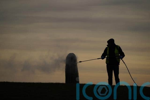 Workers were seen using a steam cleaner to slowly clear off the graffiti under the supervision of representatives of the National Monuments Service.