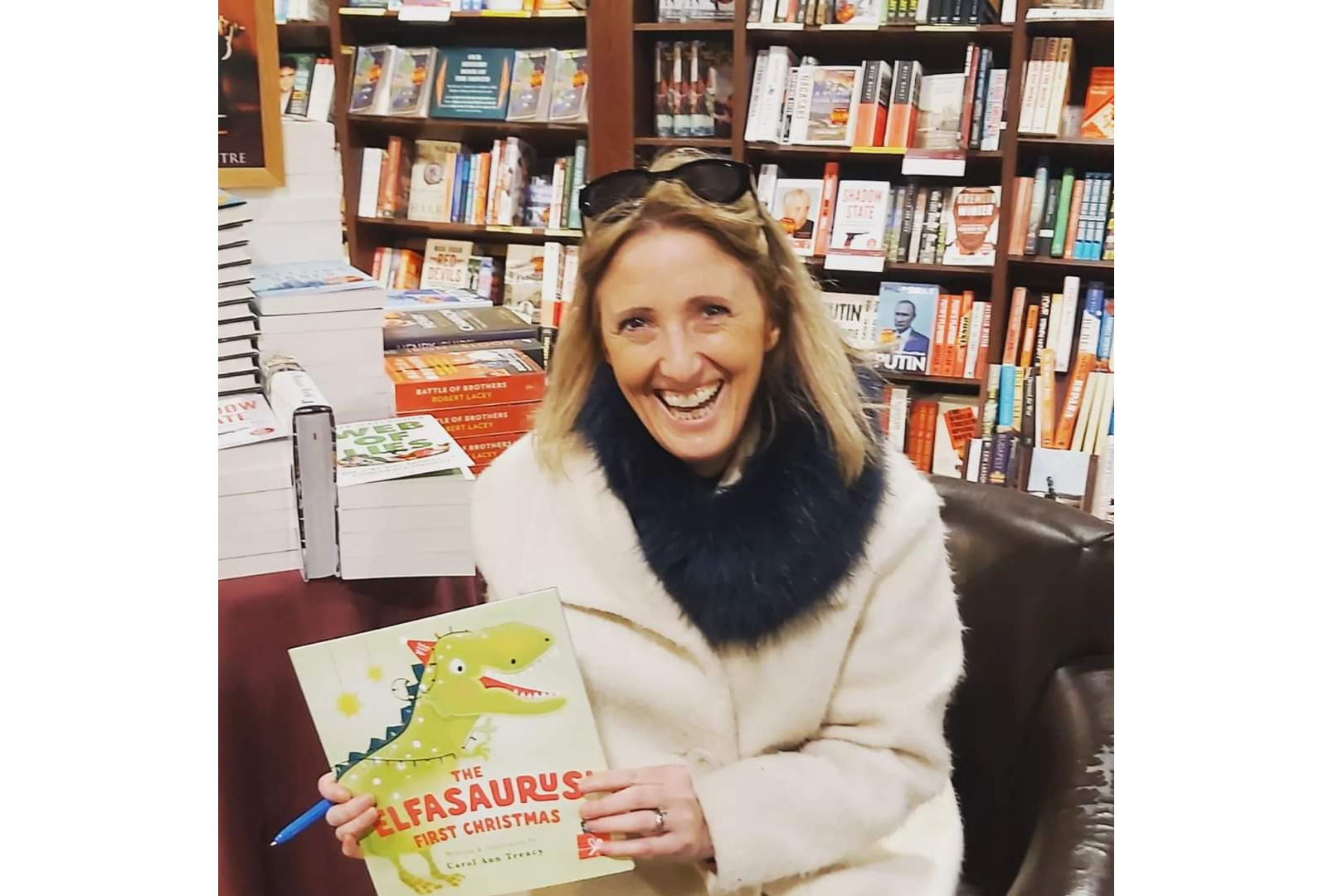 Carol Ann Treacy with her latest children’s book, The Elfasaurus’ First Christmas, which is available locally