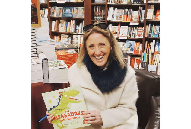Carol Ann Treacy with her latest children’s book, The Elfasaurus’ First Christmas, which is available locally