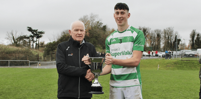Graignamanagh captain Jack Ryan receives the trophy from the Junior Board Chairman John Lacey. Pic: Willie Dempsey