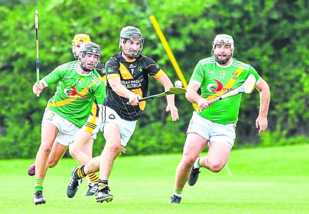 Kieran Mooney (Conahy Shamrocks) goes on a solo as Darragh Brennan and Luke Gaule (Carrickshock) give chase during their IHL clash at Tom Ryall Park. Picture: Billy Culleton