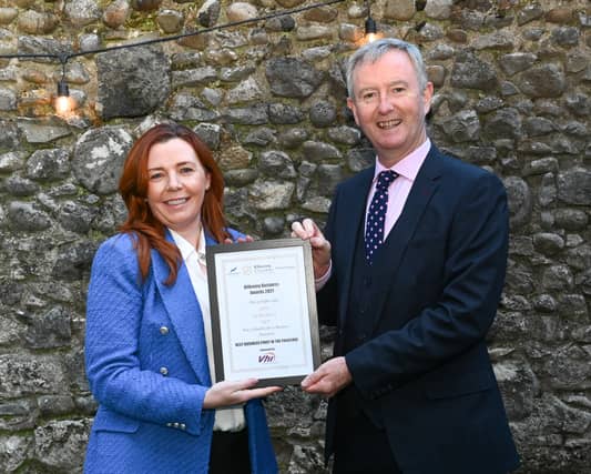 Chamber CEO John Hurley presents Lorimat with a finalist certificate