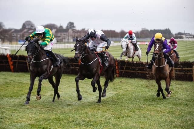 Darasso and Mark Walsh (left) begin to get on top in the closing stages of the BetVictor Limestone Lad Hurdle