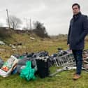 Cathaoirleach Andrew McGuinness with the bagged up rubbish at Daly's Hill
