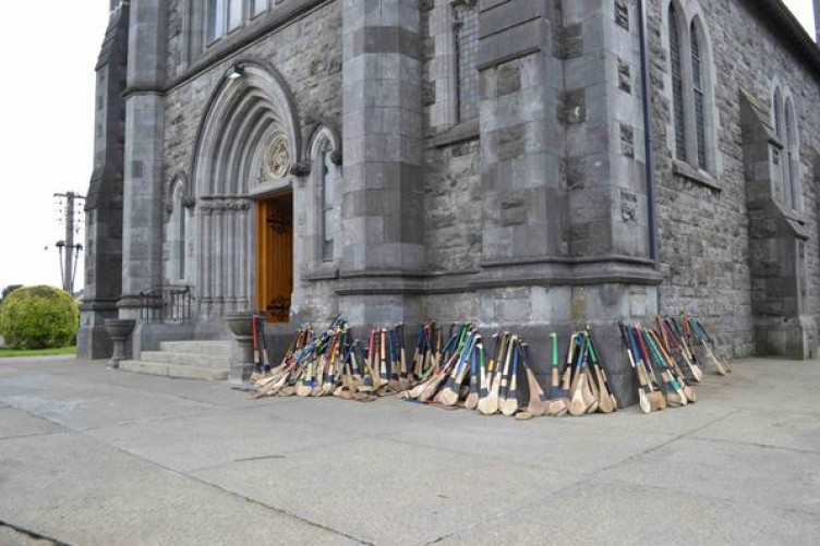 Iconic photo of the hurleys belonging to St Kieran's College, Kilkenny students outside St Patrick's Church, Kilkenny