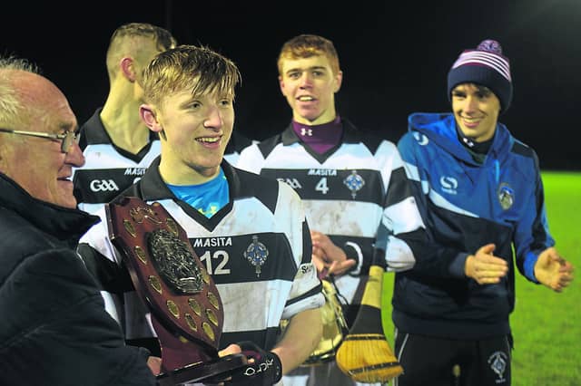 Happy man...St Kieran's College captain, Daithi Barron is presented with the winners trophy as a happy Jack Ryan looks on