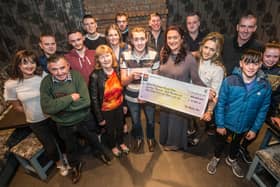 Shane Prendergast is presented with a cheque for the money raised by the benefit night held by the Hilltop Bar in Ballymurphy PICTURE: PAT MOORE