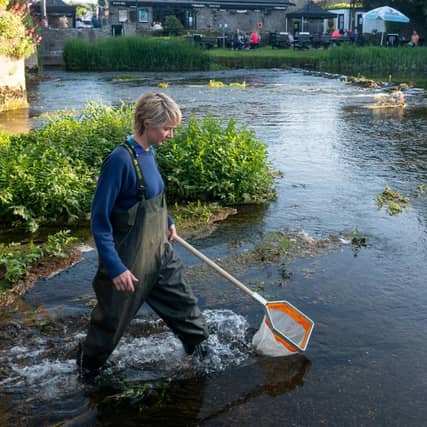 Tory Berber, Nore Vision’s Learning and Engagement Officer demonstrating how to test for water quality by using the kick sampling technique