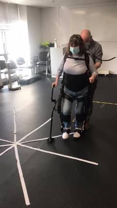 Kathleen Stapleton walking with the aid of the exoskeleton technology from DCU