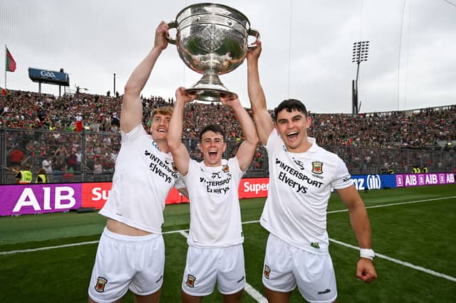 Mayo players, from left, Jack Carney, Paul Towey and Tommy Conroy celebrate with the Sam Maguire Cup following the GAA Football All-Ireland Senior Championship final match between Kerry and Mayo at Croke Park in Dublin