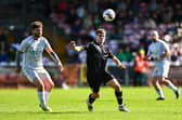 Diarmuid Behan of Evergreen in action against Mark Murphy of Coachford during the FAI Junior Cup final between Coachford and Evergreen at Munster FA Turner's Cross Park in Cork. 
