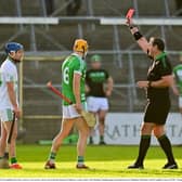 Danny Loughnane of O'Loughlin Gaels, left, is shown a red card by referee Owen Beehan during the 2021 Kilkenny County Senior Club Hurling Championship Final at UPMC Nowlan Park in Kilkenny. 