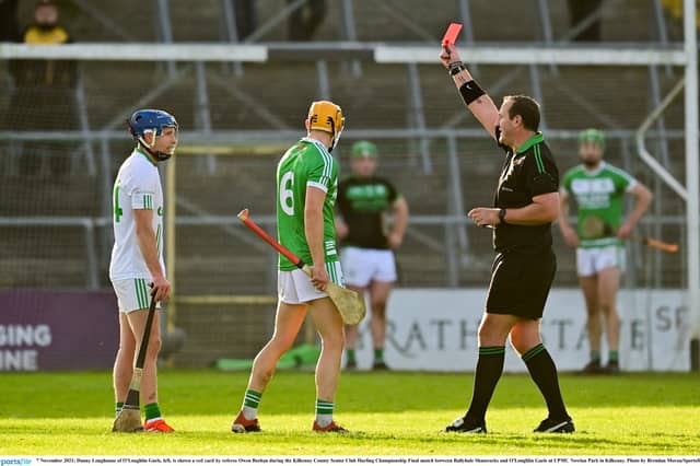 Danny Loughnane of O'Loughlin Gaels, left, is shown a red card by referee Owen Beehan during the 2021 Kilkenny County Senior Club Hurling Championship Final at UPMC Nowlan Park in Kilkenny.