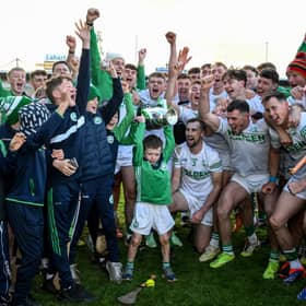 Six year old Ronan Sheflin together with Joey Holden, captain of Ballyhale Shamrocks, and squad members and supporters celebrate with The Tommy Walsh Cup after the Kilkenny County Senior Club Hurling Championship final match between Ballyhale Shamrocks and Tullaroan at UPMC Nowlan Park in Kilkenny. 