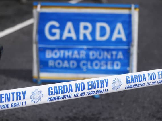 Garda crime scene tape and road closed sign